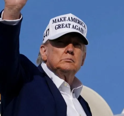 Donald Trump waving while exiting Air Force One during EU trade talks.