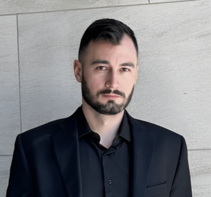 Dorin Ghilescu, founder of BMG Real Estate, in front of a premium commercial property, symbolizing his branding-first approach to real estate development.