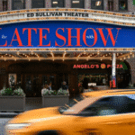 Stephen Colbert on the set of The Late Show, engaging with the studio audience during a taping.