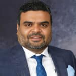 Portrait of Anil Jain associated with Refex Industries and its business expansion.